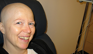 Sheila, bald from treatment, smiling