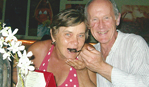 Rita and her husband Edward, laughing together at dinner