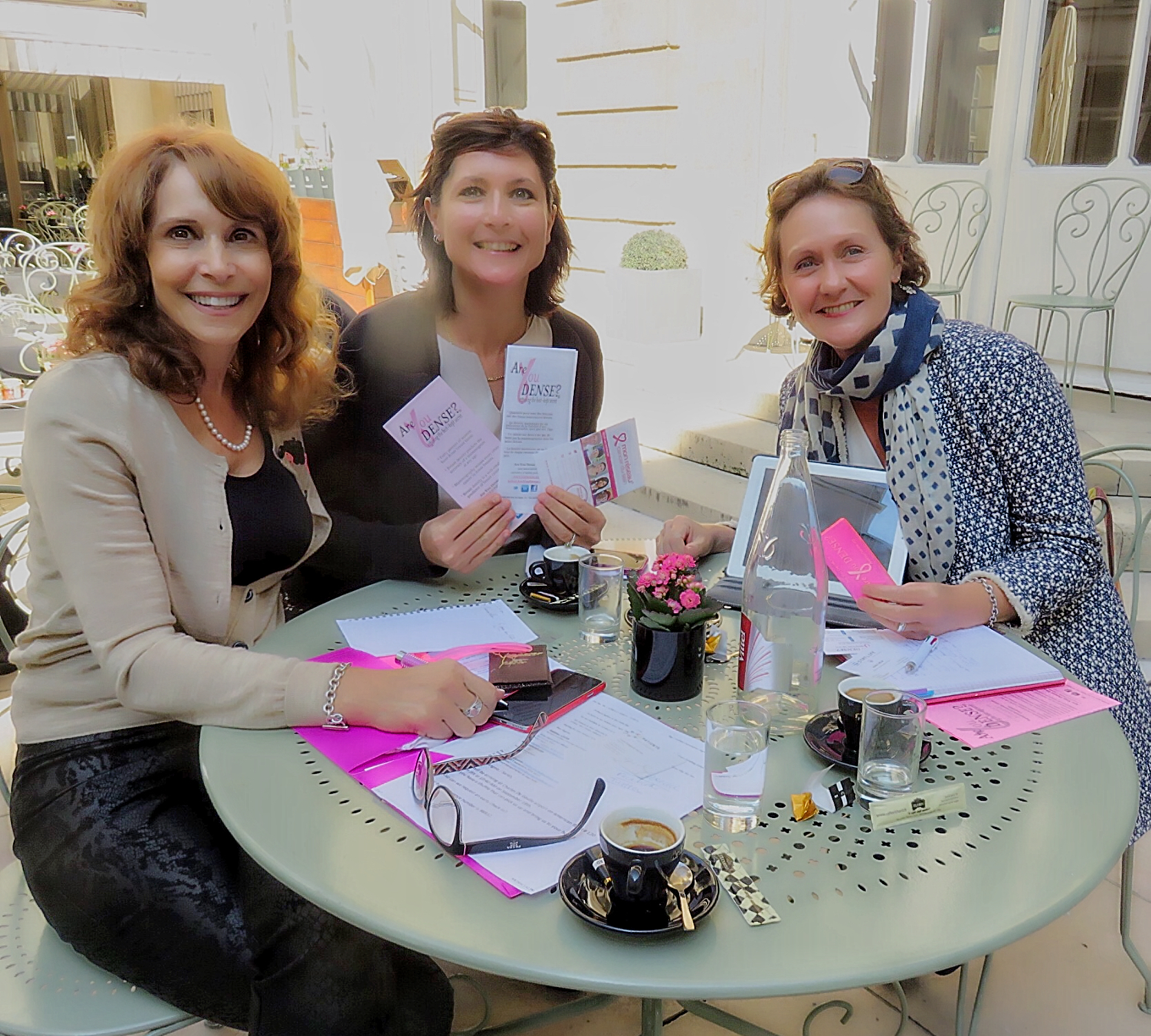 Dr. Cappello meeting patient advocates over coffee at an outdoor table in Paris