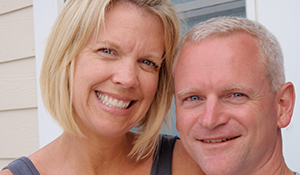 Julie and a loved one, smiling cheek to cheek