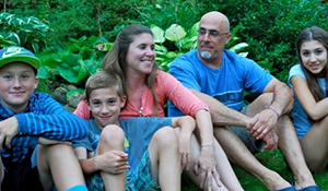 April with her family, sitting together outdoors