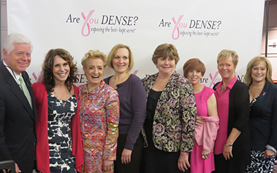 Congressman John Larson with Dr. Cappello and advocates in front of the Are You Dense? backdrop