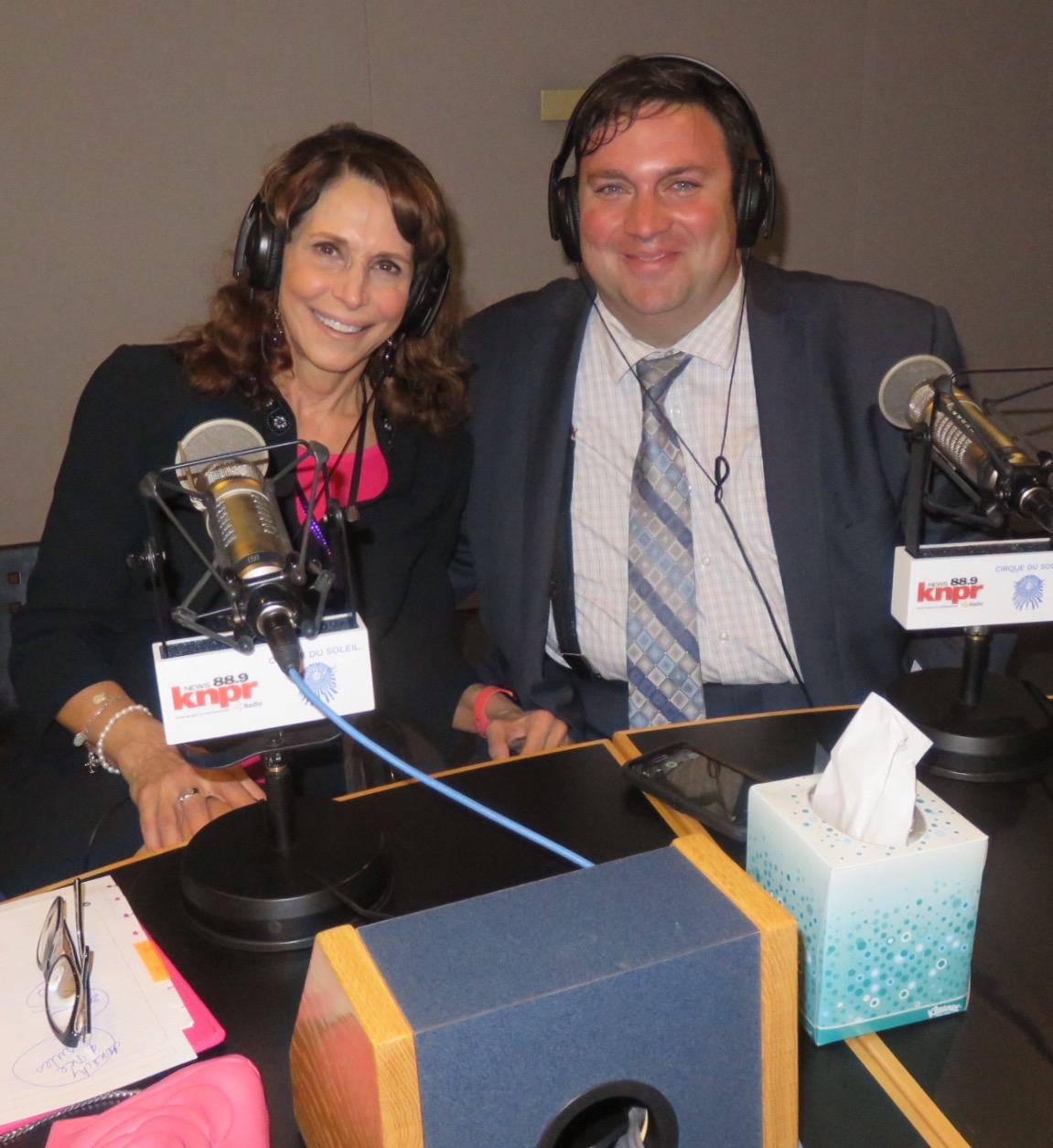 Dr. Cappello and a fellow guest wearing headphones at the KNPR Nevada Public Radio studio microphones