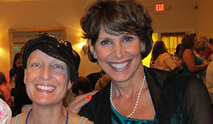 Claudia and a friend smiling at an event