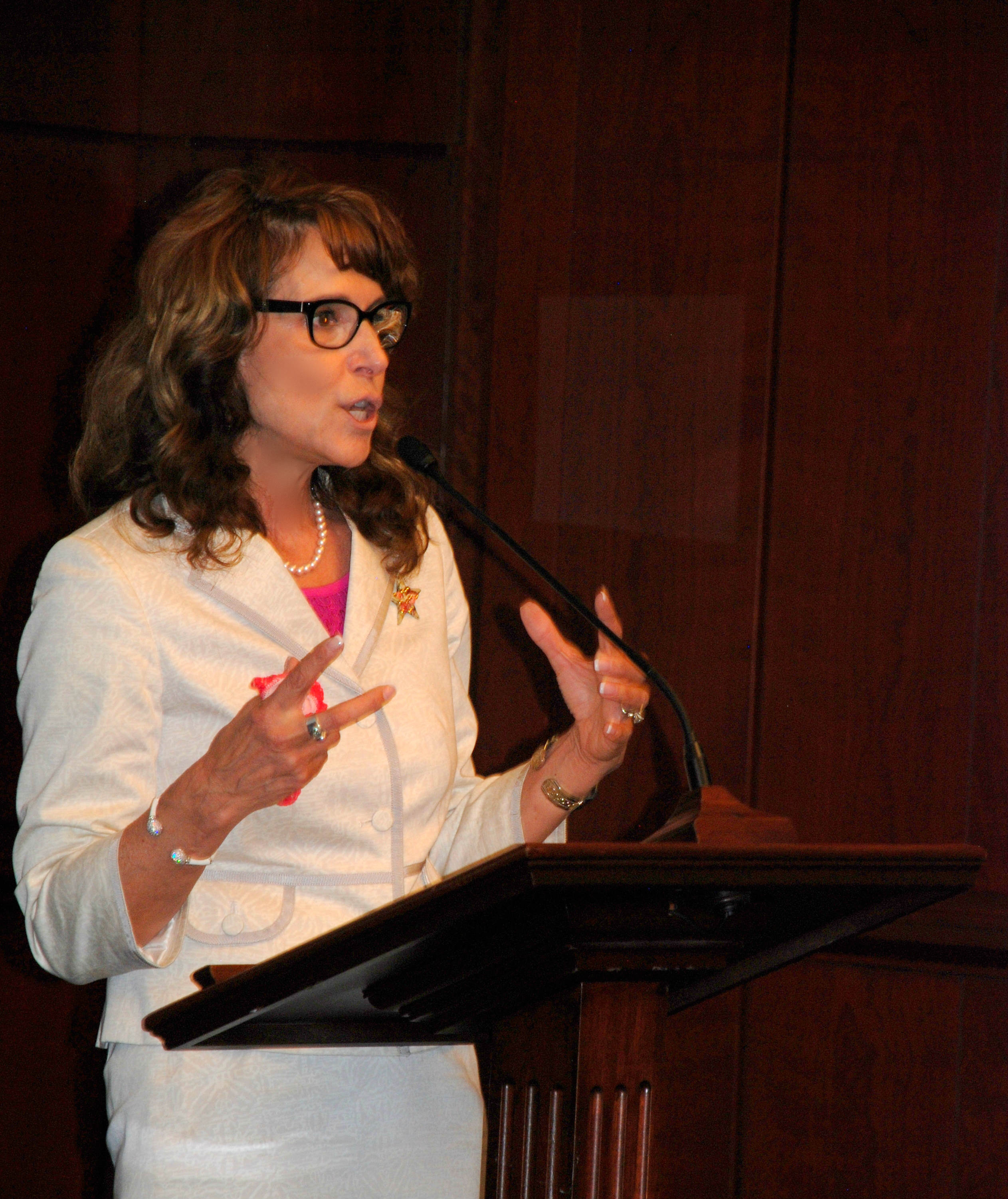 Dr. Cappello speaking at a podium at the U.S. Senate staff briefing