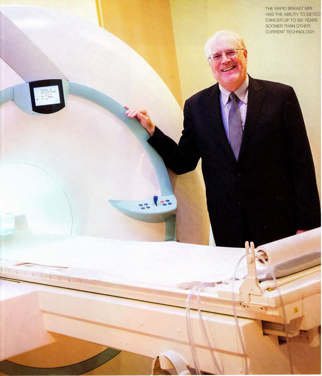 Dr. David Strahle standing beside a breast MRI scanner
