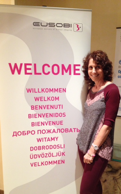 Dr. Cappello beside a EUSOBI banner saying welcome in many languages