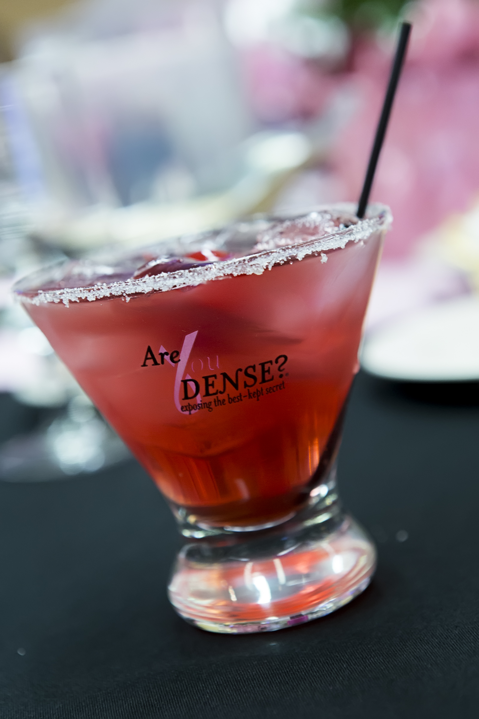 Pink cocktail in an Are You Dense? glass