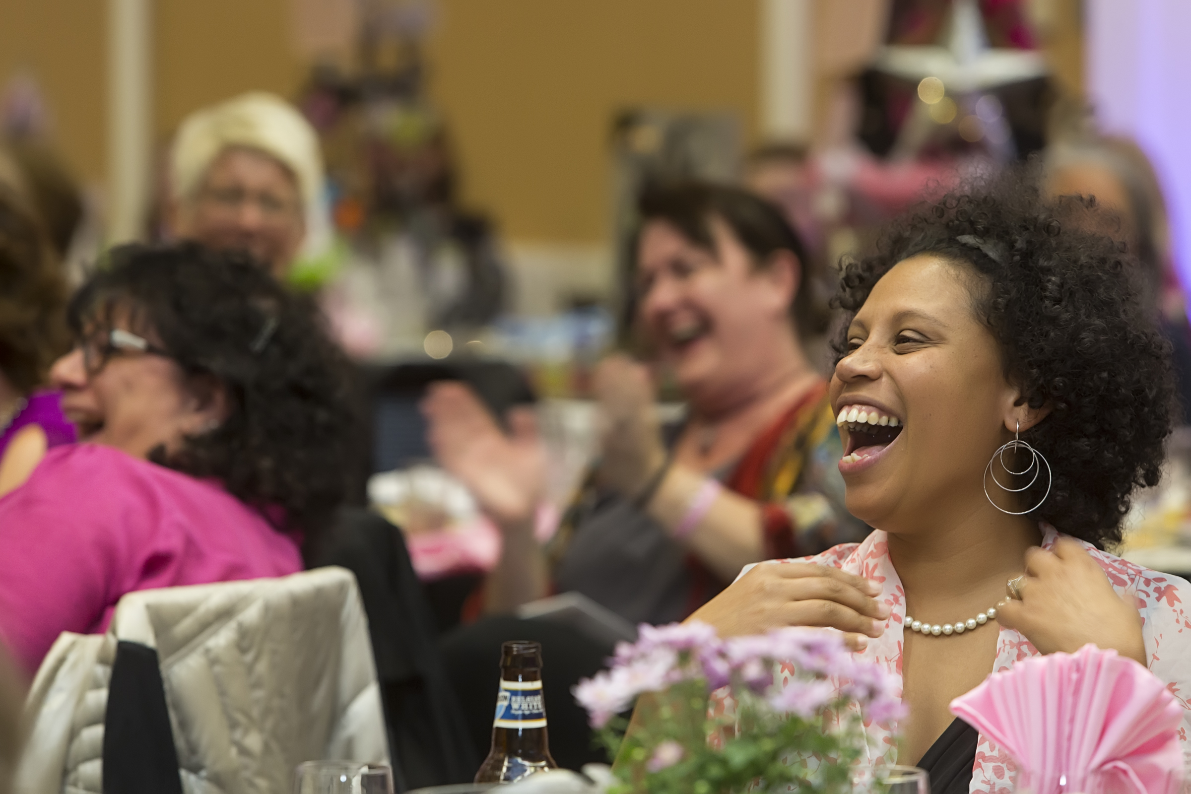 Guests laughing at their tables during the evening