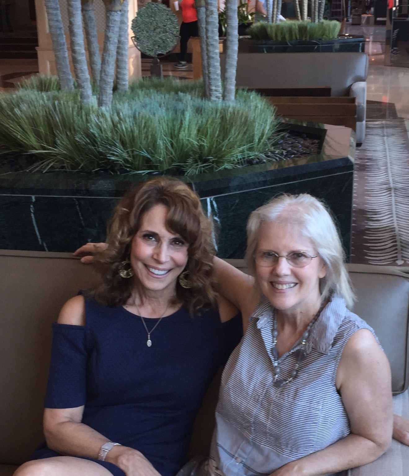 Dr. Cappello and Lorilyn Roberts seated together in a hotel lobby