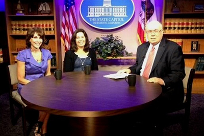 Three guests seated at a round table on The State Capitol TV set in Sacramento