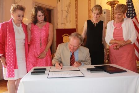 Governor Chafee signing Rhode Island's density reporting bill as Dr. Cappello and Ann Galligan Kelley look on